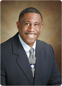 Headshot of Dr. Calvin T. Wilson II, MD, Clinical Advisor to CCRX, in a suit and tie against a neutral backdrop.